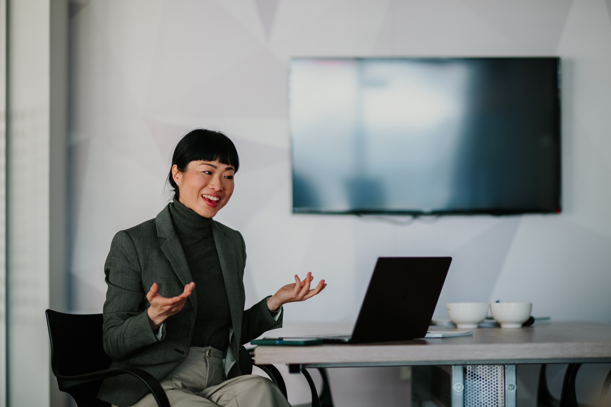Asian businesswoman leading a video conference in modern office