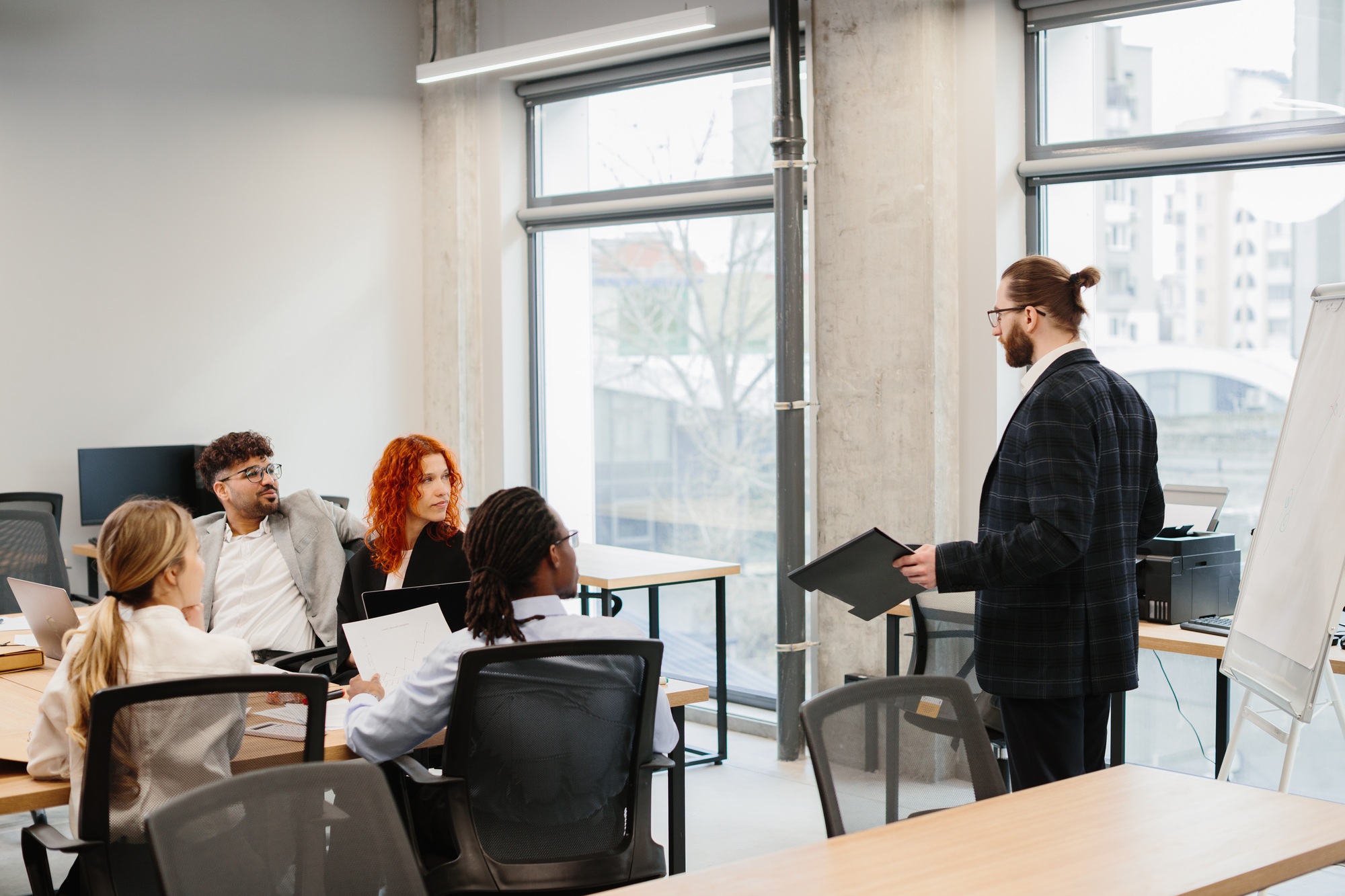 Businessman leading a presentation to his diverse team in the office