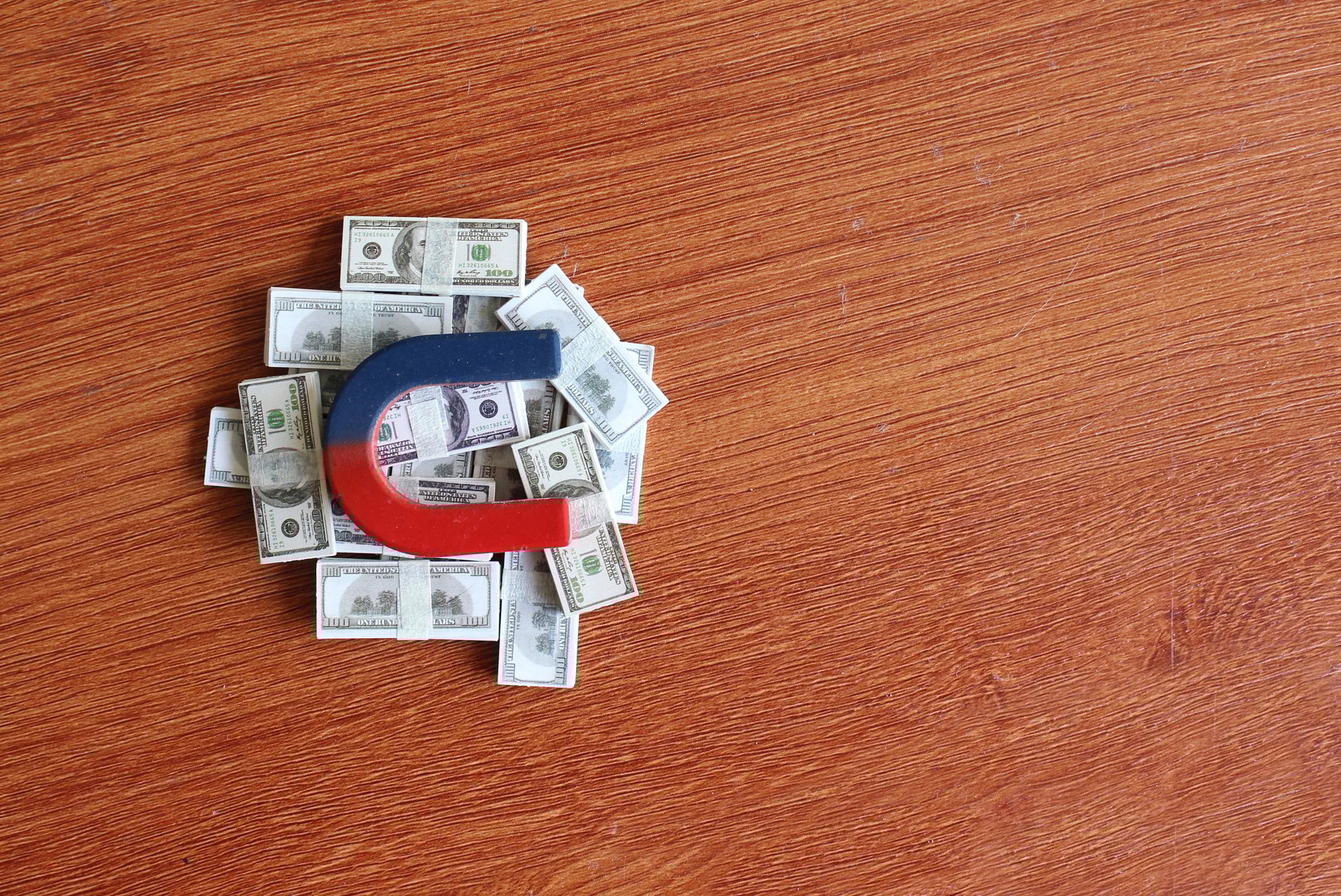 Magnet on top of pile of money.