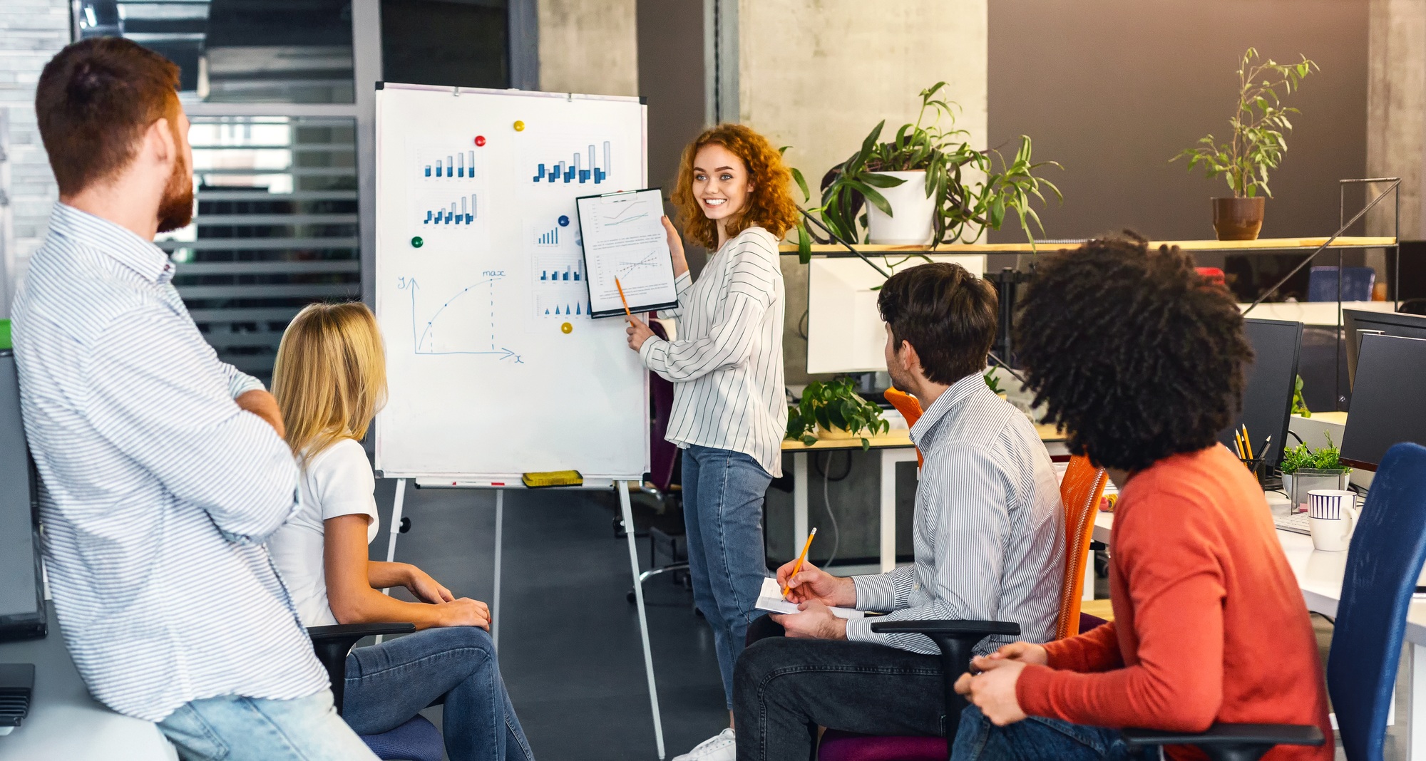 Young Woman Professional Leading Team Meeting in Modern Office Space