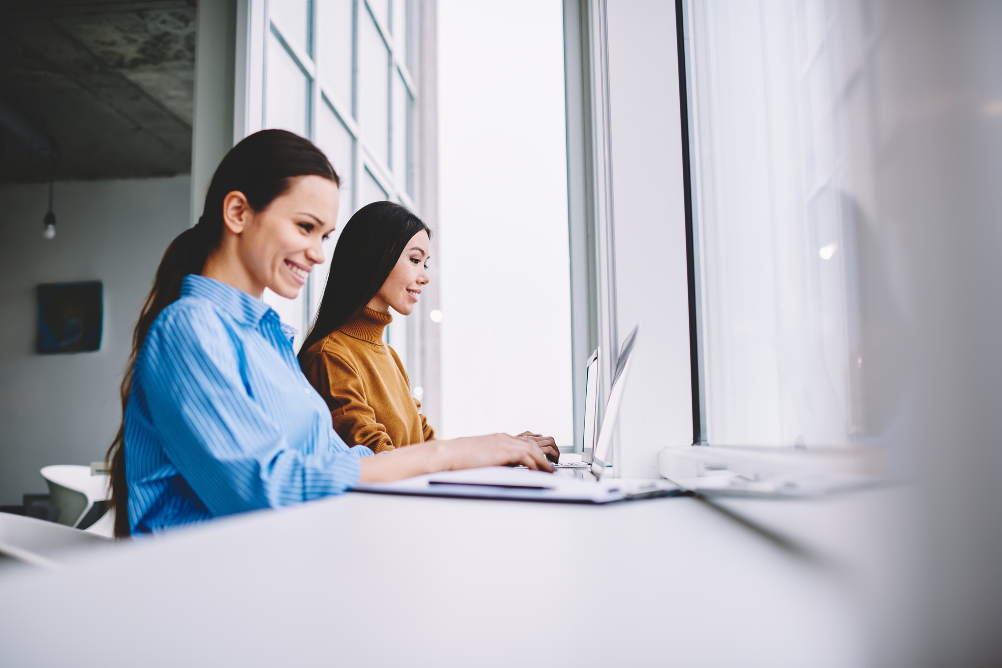 cheerful employees sharing media content during brainstorming programming and networking