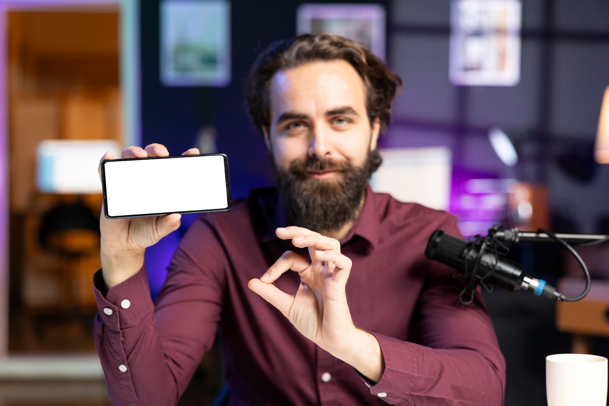 Man holding isolated screen smartphone in hand, using it as empty copy space