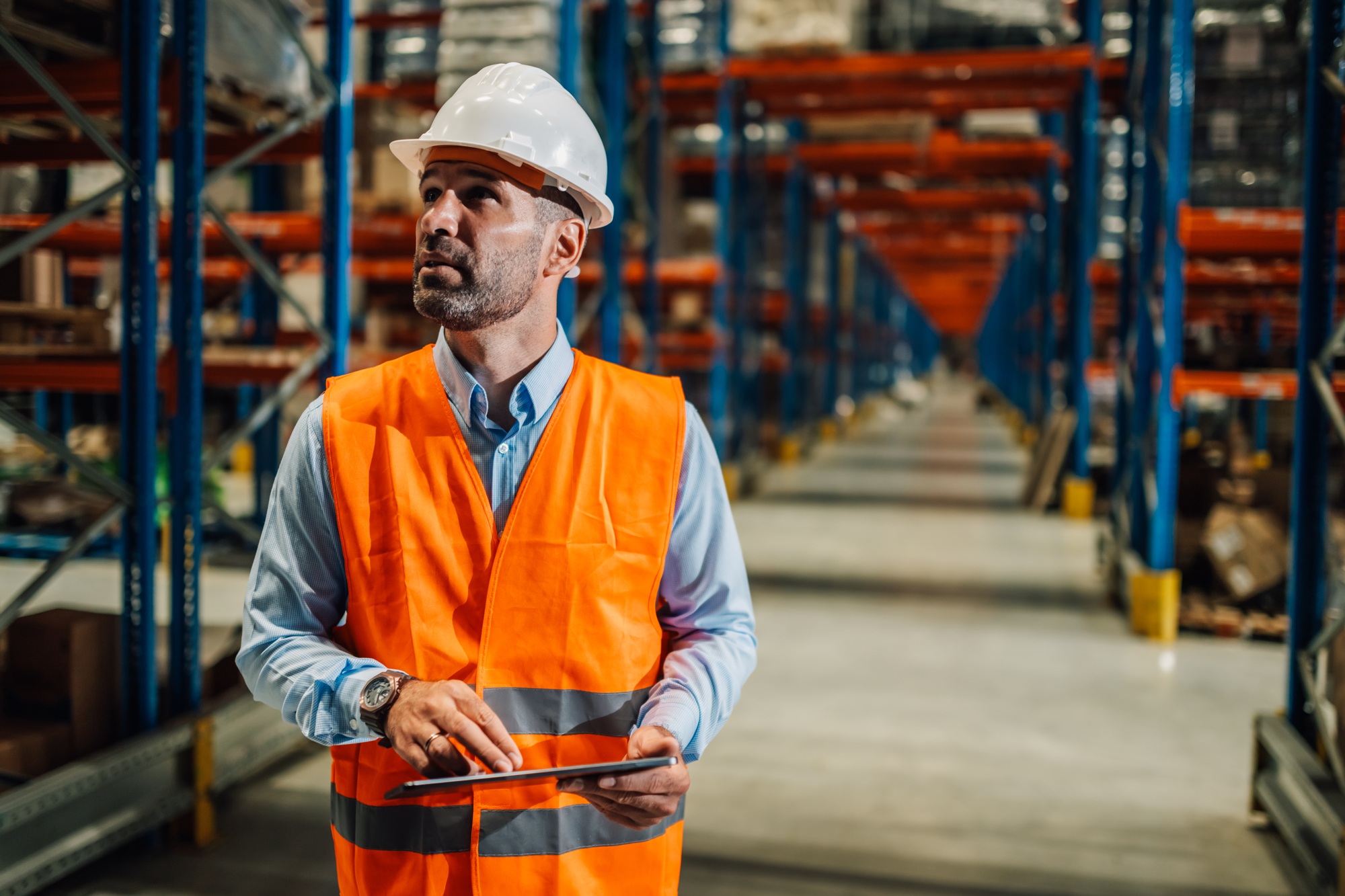 Supervisor using digital tablet and controlling inventory in warehouse