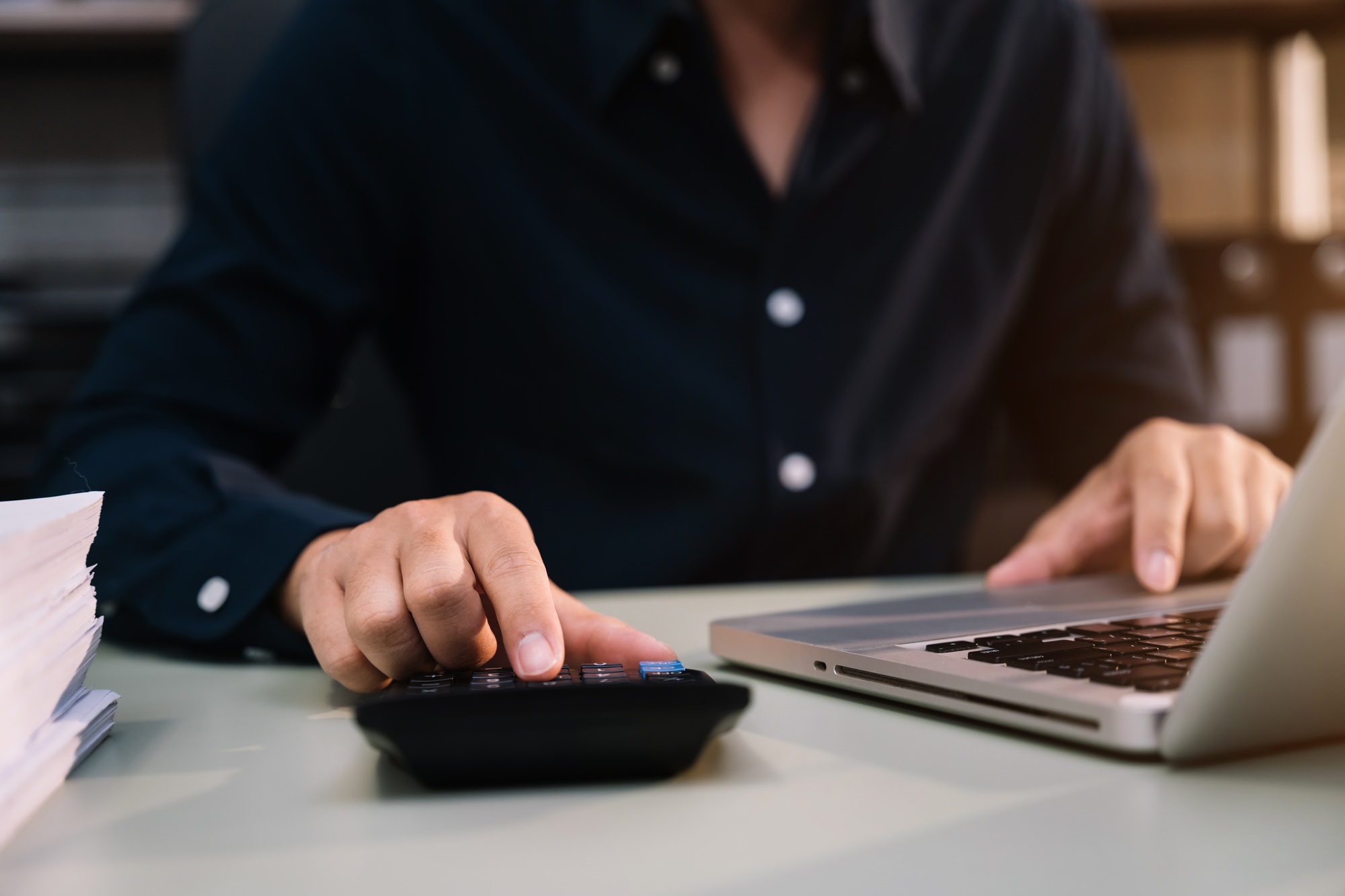 Analysts discuss business with a calculator as a tool.