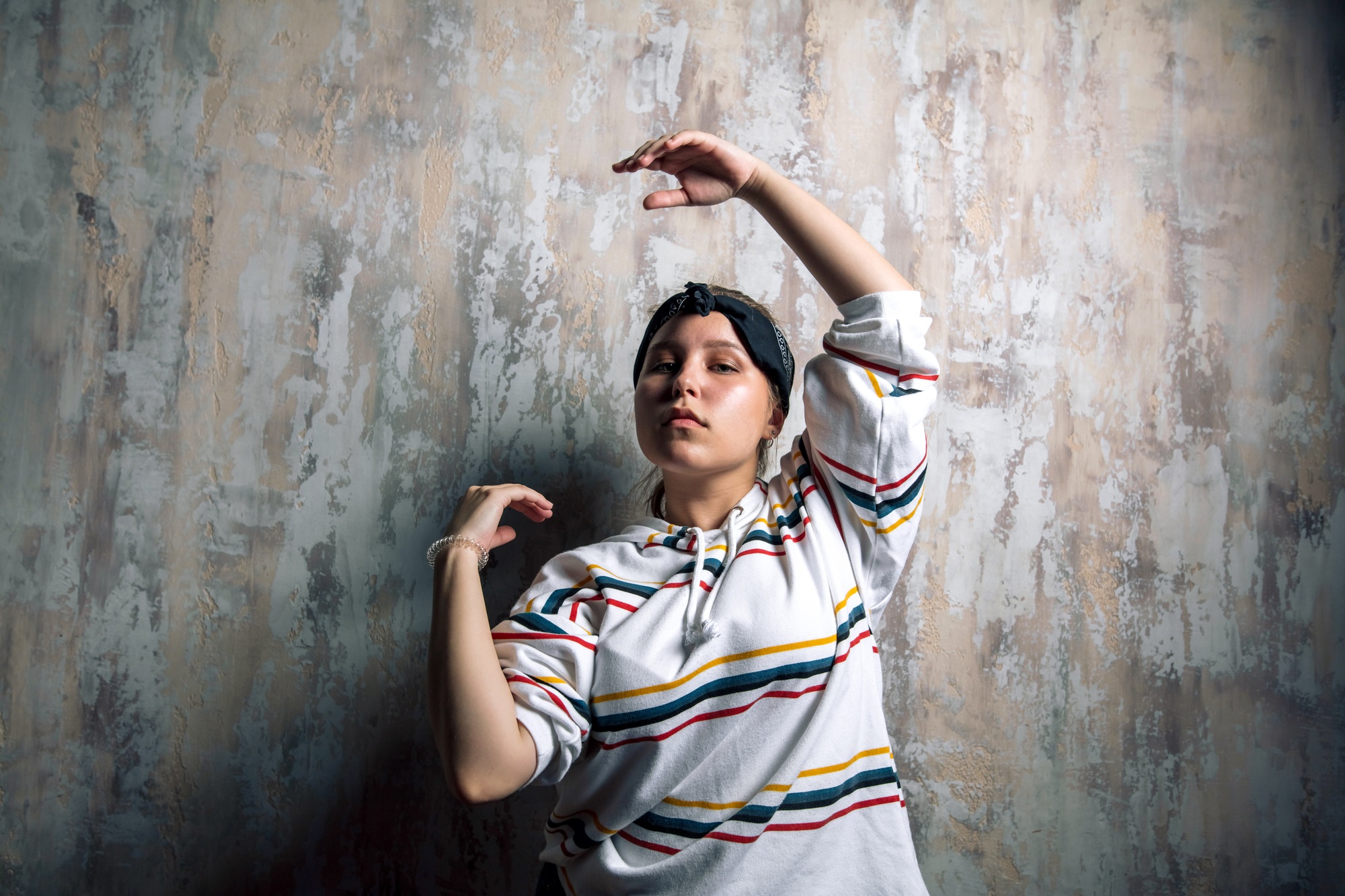 emotional talented female hip hop dancer doing some moves with arms