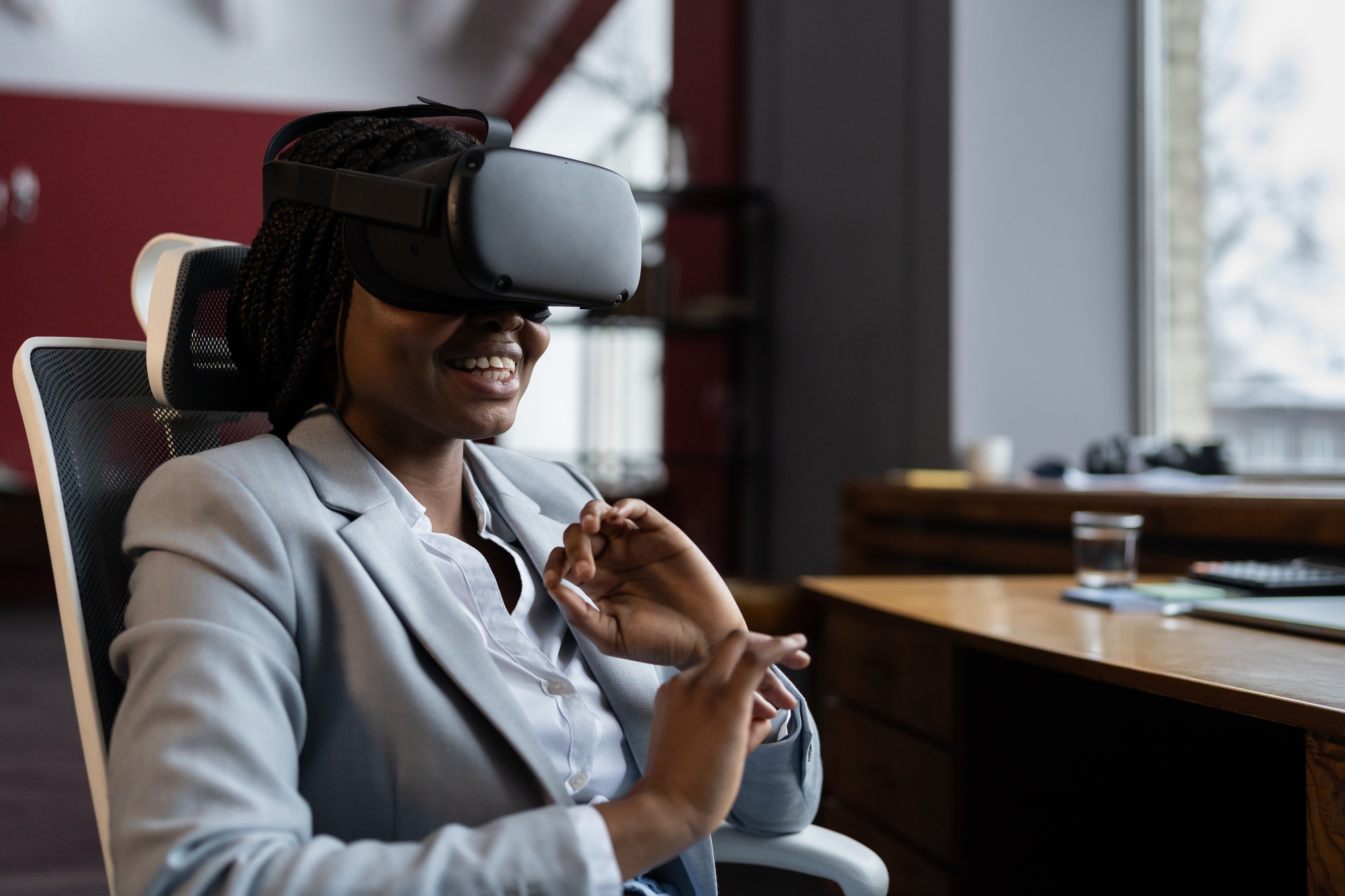 VR in workplace. Smiling african female employee during corporate training in virtual reality