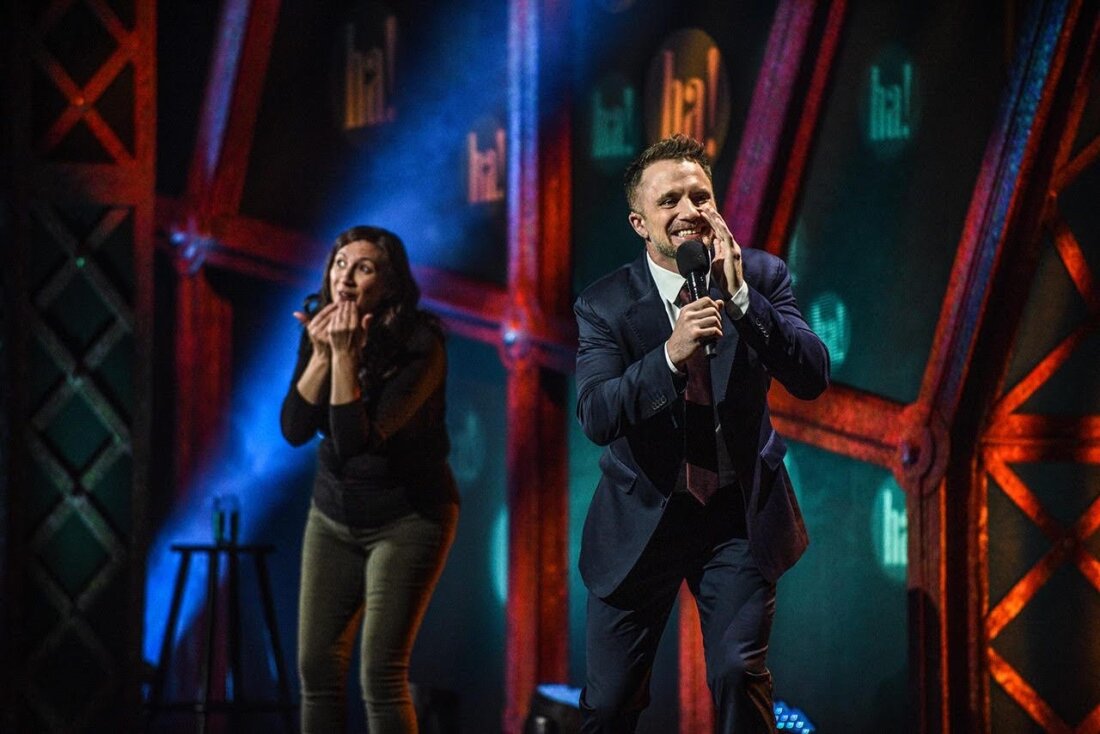 To reach others in the deaf community, stand-up comedian D.J. Demers is often joined on stage by a sign language interpreter. Jennifer Lees (left) has interpreted many of his performances including the 2024 All Access Comedy Show in Halifax, Nova Scotia.