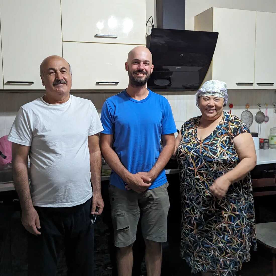 A local family in Uzbekistan's capital city of Tashkent hosted Nok, center, in August. The son of the couple pictured, who showed him around the city, took this photo at their home.