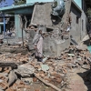 Soldiers in Indian-administered Kashmir blew up the family homes of two men suspected of carrying out Tuesday's deadly attack on tourists in Pahalgam. People walk through the debris of a demolished house related to the family of one of the suspects in southern Kashmir on Friday.