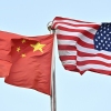Chinese and U.S. flags wave outside a technology company in Beijing, on April 17.