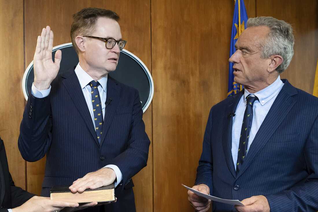 In this photo provided by the Department of Health and Human Secretary, Robert F. Kennedy Jr., right, conducts the swearing-in ceremony of Jim O'Neill as the department's deputy secretary, June 9, 2025, in Washington, D.C.