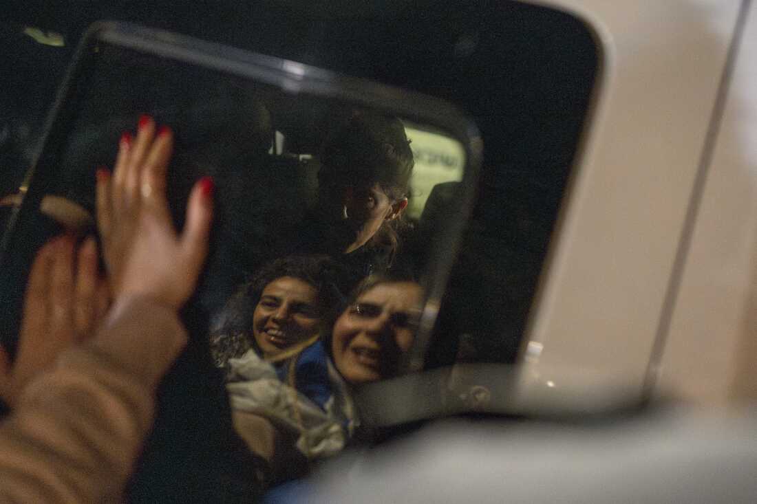 People celebrate as Freed Israeli hostages arrive in Ramat Gan after their release from Hamas captivity in the Gaza Strip on Jan. 19, 2025.