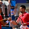 Serbia's Novak Djokovic, right, shakes hands with Spain's Rafael Nadal after the two faced off in the Paris Olympics — their 60th matchup overall. Nadal has been battling injuries for years, but he rallied for a number of dramatic points in front of an appreciative crowd at Court Philippe-Chatrier at the Roland-Garros Stadium at the Paris 2024 Olympic Games, in Paris on July 29, 2024. (Photo by Martin BERNETTI / AFP) (Photo by MARTIN BERNETTI/AFP via Getty Images)