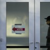 A poll worker monitors voting at a polling place at the Arizona State University campus, Tuesday, Nov. 5, 2024, in Phoenix, Ariz. 