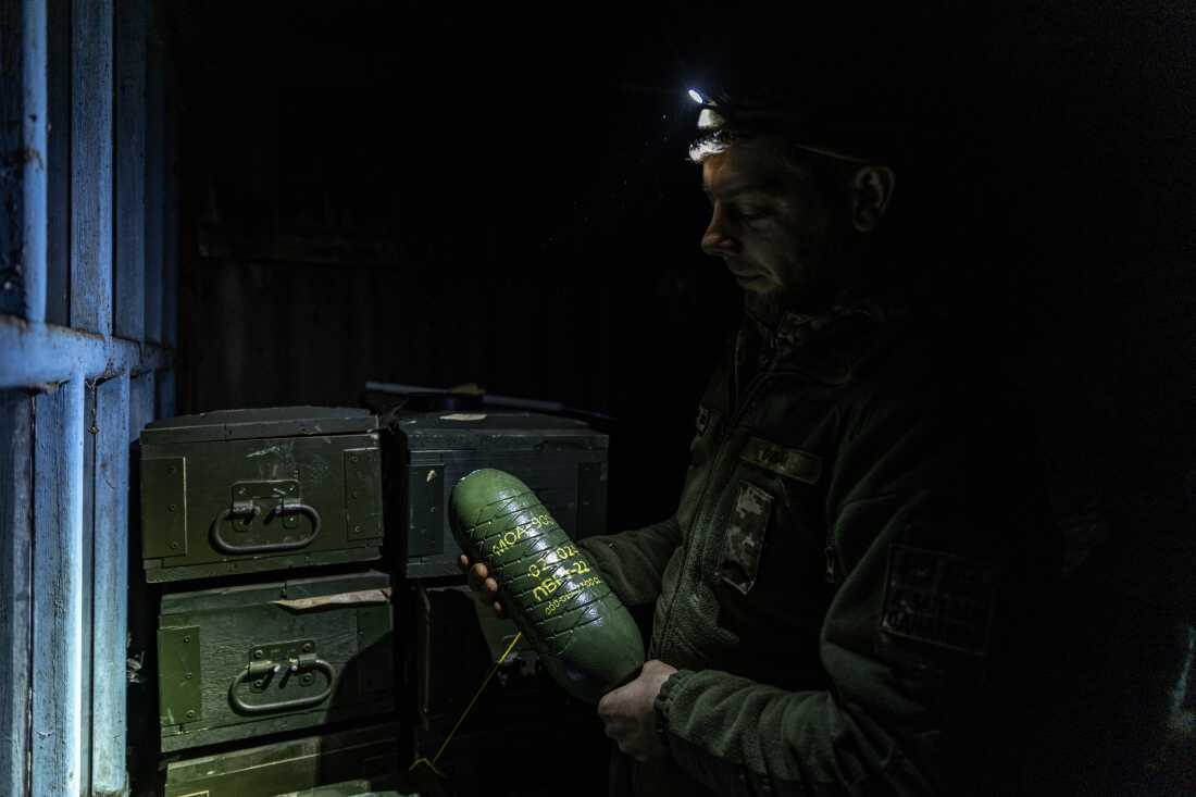 Callsign "Babai", drone pilot and explosives technician of Dovbush's hornets unit of 68th Separate Jäger Brigade holds in hands mortar munition. The unit uses it for dropping from drones.