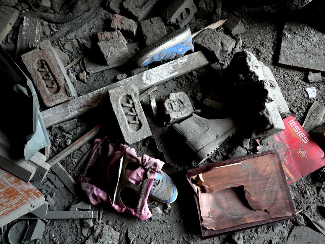 Shoes covered in dust and bricks in a destroyed house in Murran village in the Pulwama district, Kashmir, on April 26,2025.