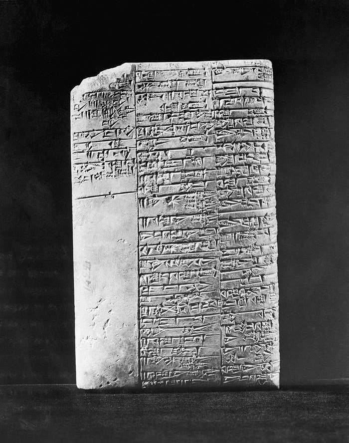 Ancient clay tablet with cuneiform script, featuring multiple lines of text