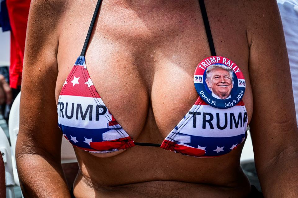 Person wearing a bikini with "Trump" print and a rally button pinned on it