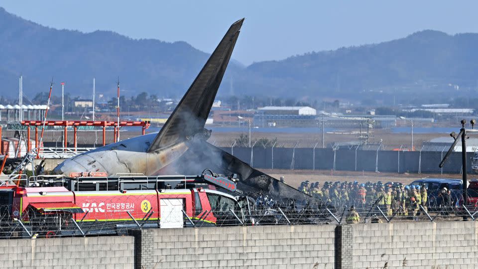 Firefighters and rescue team members work on the runway of Muan International Airport in Muan, South Korea, Sunday, Dec. 29, 2024. (Lee Young-ju/Newsis via AP) - Lee Young-ju/Newsis/AP