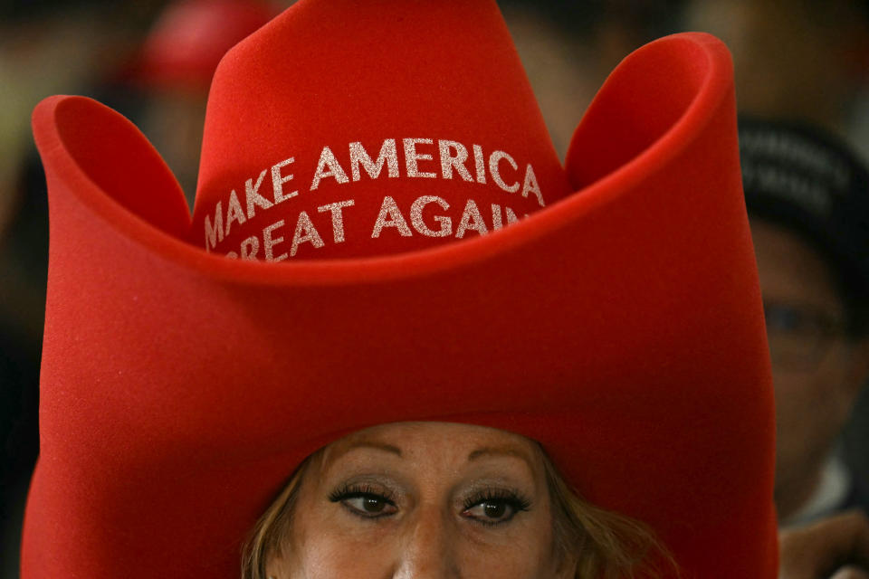Person wearing a large hat with "Make America Great Again" text visible on it