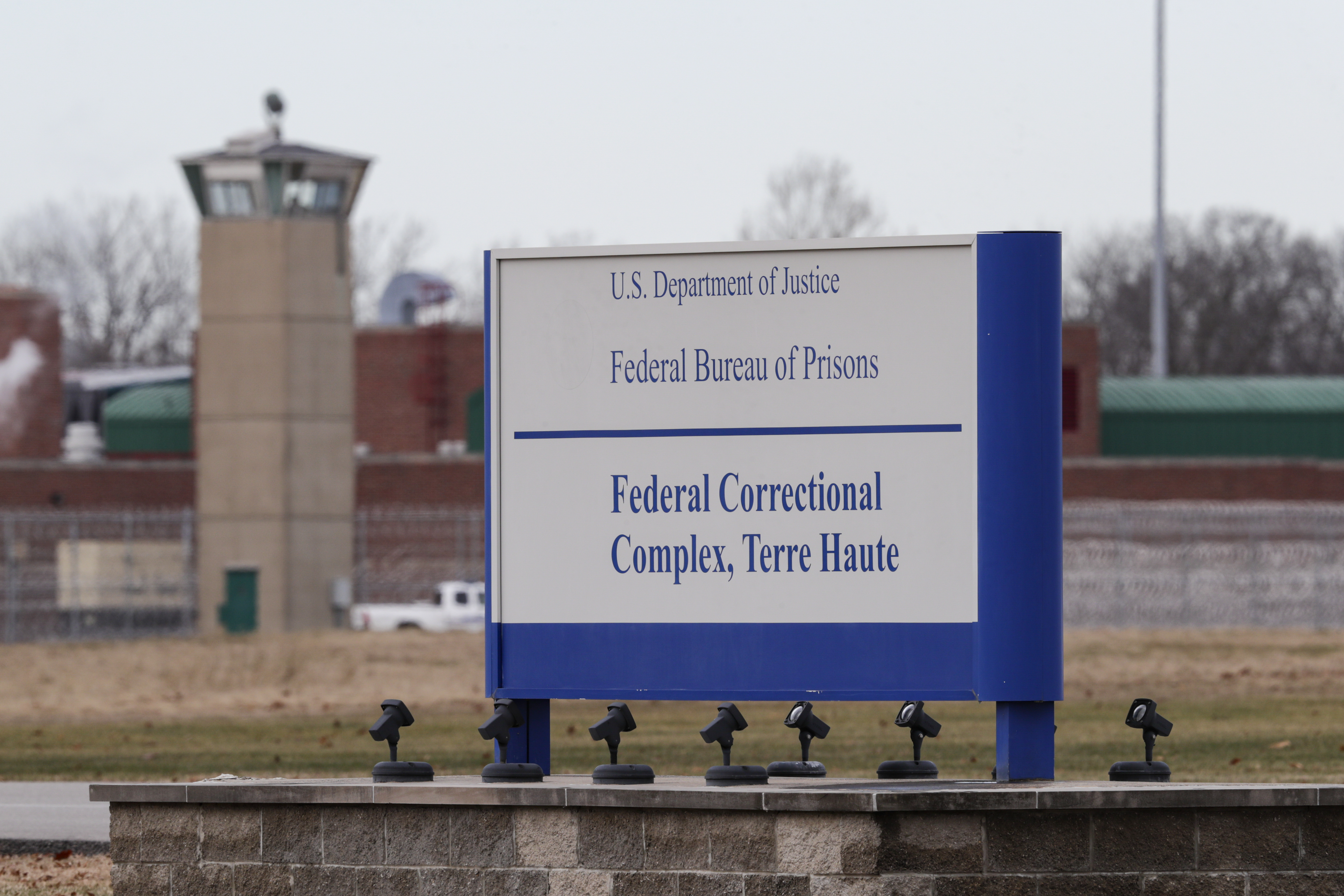 The guard tower flanks the sign at the entrance to the U.S. Penitentiary in Terre Haute, Ind., in Terre Haute, Ind., Tuesday, Dec. 10, 2019. The facility houses a Special Confinement Unit for male federal inmates who have been sentenced to death as well as the federal execution chamber. (AP Photo/Michael Conroy)