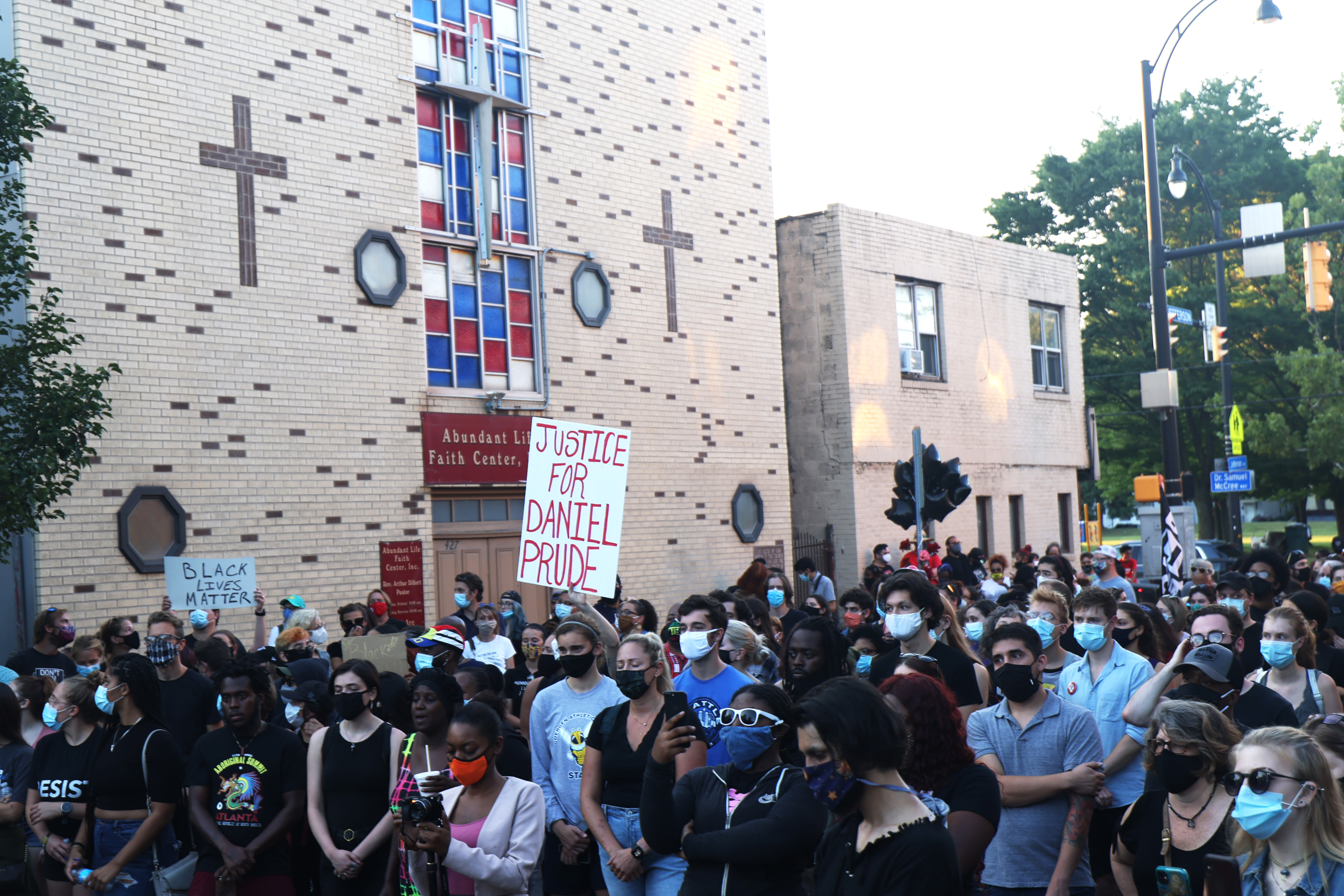 ROCHESTER, NEW YORK - SEPTEMBER 03: Demonstrators listen to speakers at the site where Daniel Prude was arrested after marching from a community gathering on September 03, 2020 in Rochester, New York. Prude died after being arrested on March 23 by Rochester police officers who had placed a "spit hood" over his head and pinned him to the ground while restraining him. Mayor Lovely Warren announced today the suspension of seven officers involved in the arrest. (Photo by Michael M. Santiago/Getty Images)