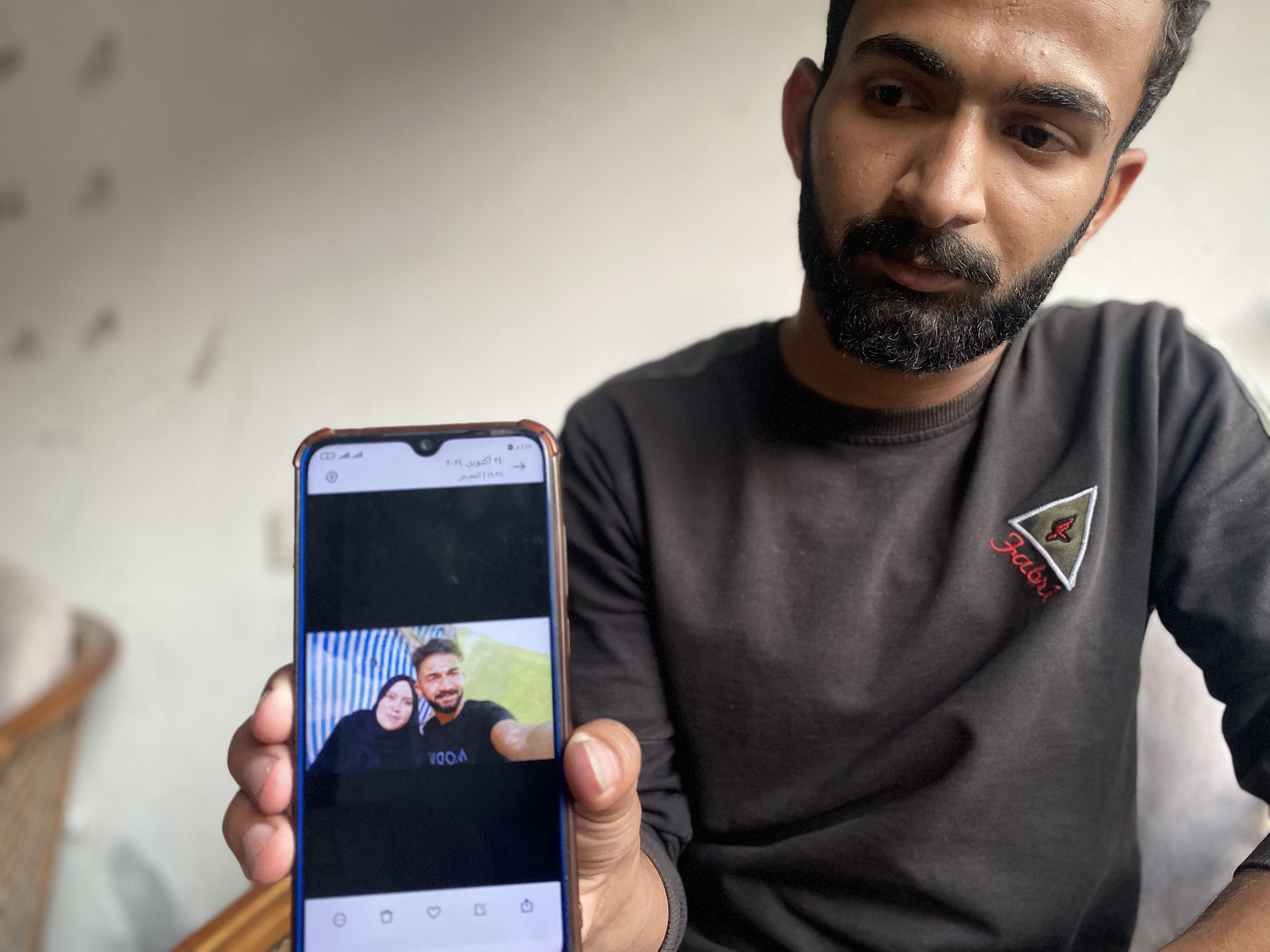 Ramez Abu Nasser displays a selfie he took with his mother before she was killed in an Israeli strike, on November 4, 2024.